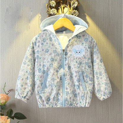 Detailed shot of the zipper and floral pattern on a toddler girls' cotton windbreaker.