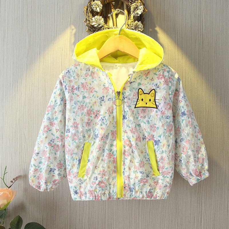 Toddler girl model wearing light blue floral bunny ear hooded windbreaker, side view.