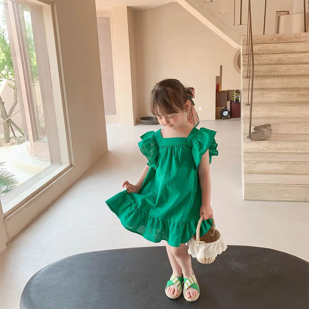 Folded denim blue short sleeve A-line kids' dress, highlighting the comfortable cotton blend.