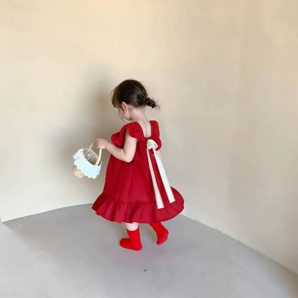 Set of two girls' short sleeve A-line summer dresses, one striped and one solid, for toddlers.