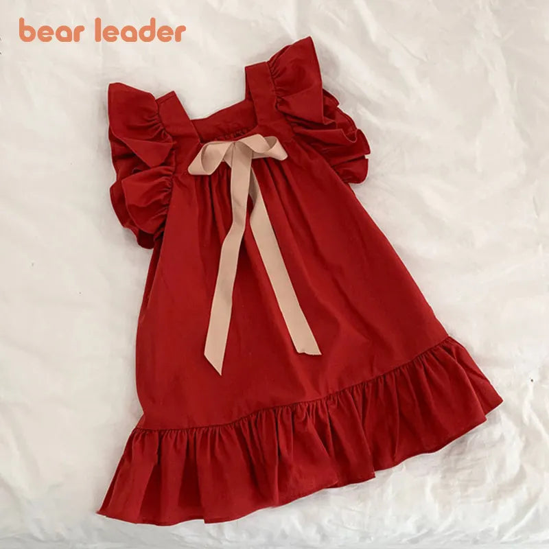 Close-up of a pink girls' short sleeve A-line summer dress with square collar and gentle gathers.