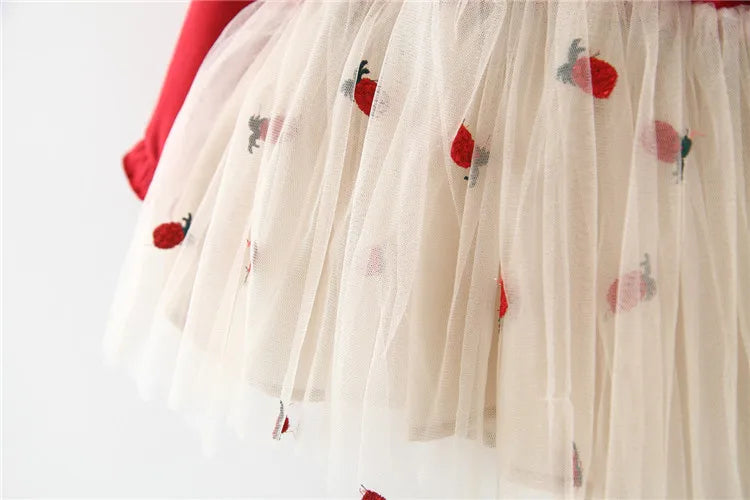 Flat lay of a red lace long sleeve toddler dress, showcasing its elegant design and fabric.
