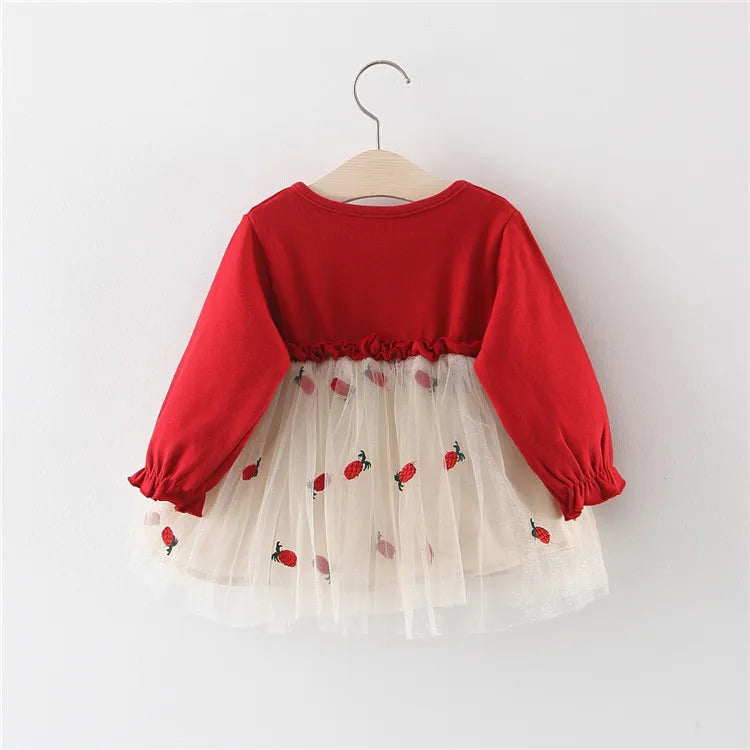 Close-up of the long sleeve and lace cuff on a red princess dress for infant girls.
