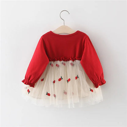 Close-up of the long sleeve and lace cuff on a red princess dress for infant girls.