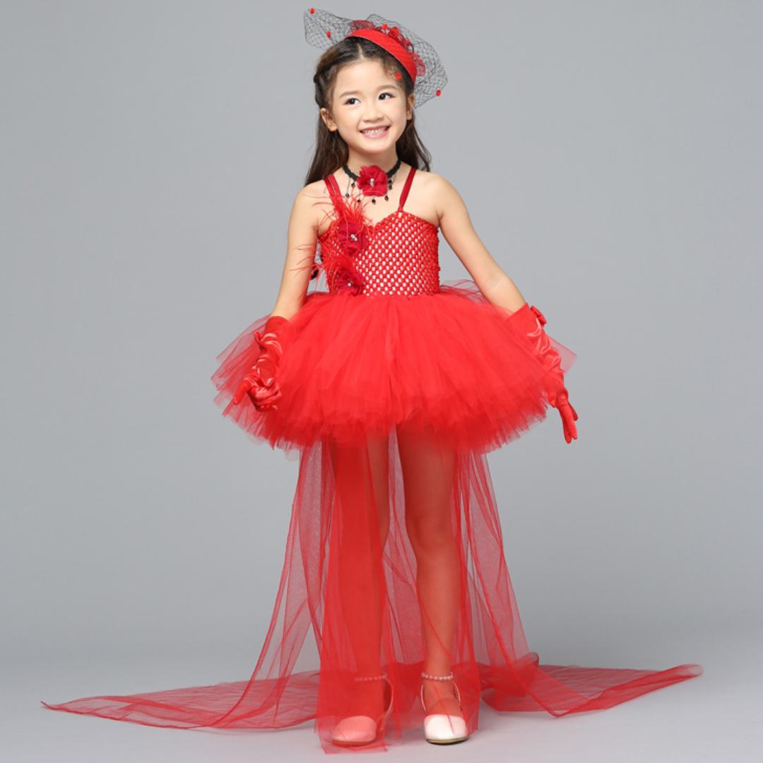 Girl proudly wearing a vibrant red Pop Princess Halloween costume dress with tiara.