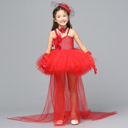 Girl proudly wearing a vibrant red Pop Princess Halloween costume dress with tiara.