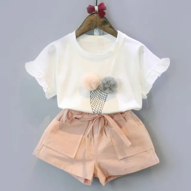 Detail shot of the polka dot pattern on a girls' beige summer short sleeve two-piece outfit set