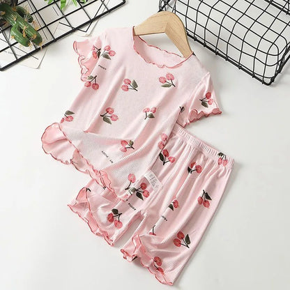 Close-up of cherry print on soft modal cotton girls' summer pajamas, comfortable kids sleepwear