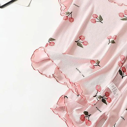 Full view of a girls' pink modal cotton short pajama set with an all-over cherry print, sizes 1-8