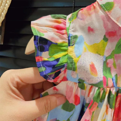Vibrant floral print girl's summer dress with unique flying sleeve detail