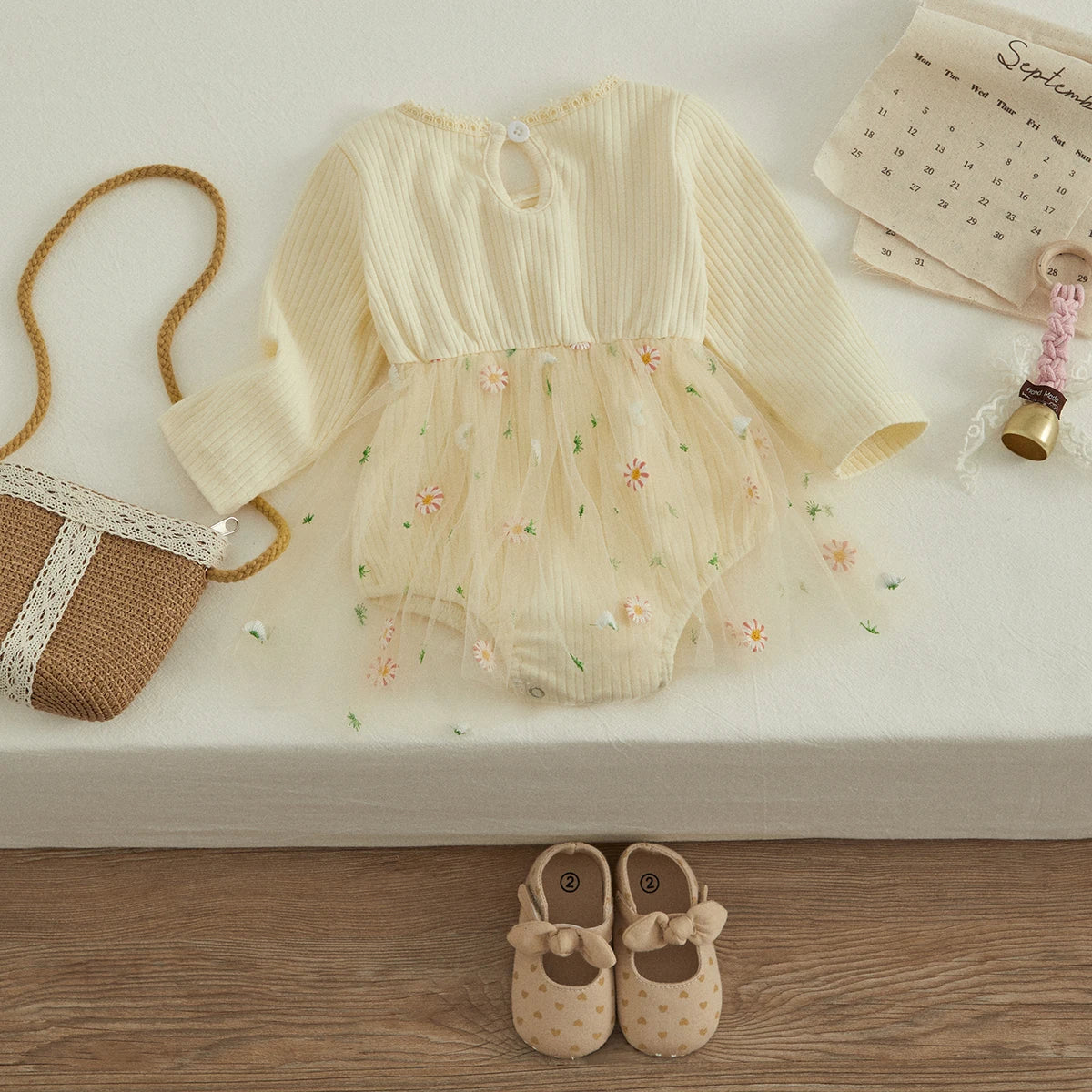 Close-up of a toddler girl's knit autumn romper, showing soft fabric and O-neck.