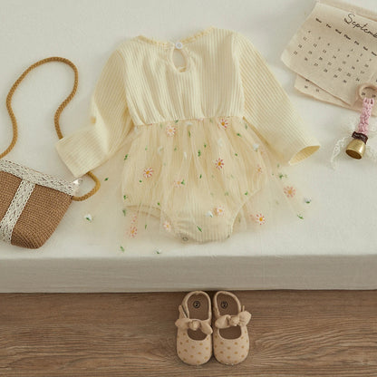 Close-up of a toddler girl's knit autumn romper, showing soft fabric and O-neck.