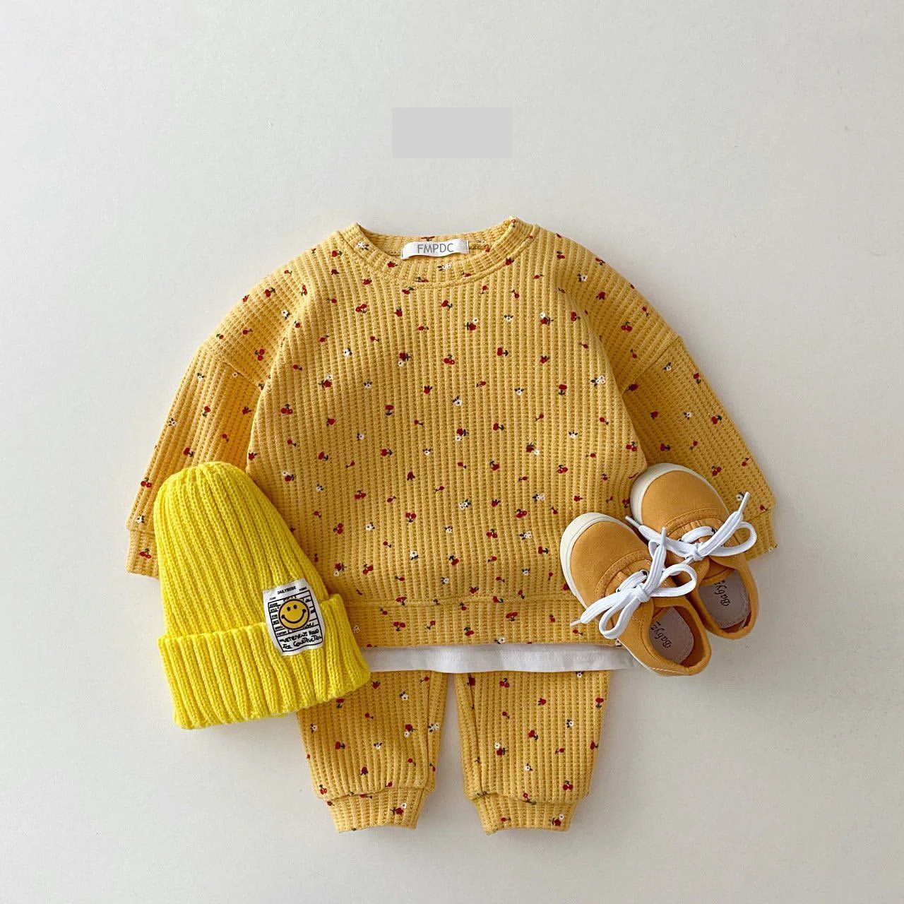Toddler girl modeling a comfortable multi-print cotton clothes set, ideal for infant spring/autumn fashion.