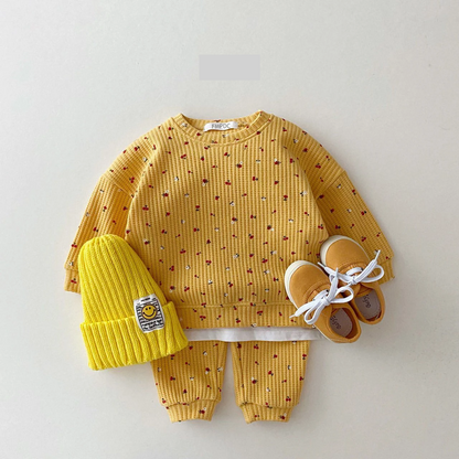Toddler girl modeling a comfortable multi-print cotton clothes set, ideal for infant spring/autumn fashion.