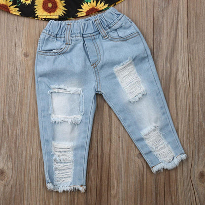 Fashionable girls' summer set: off-shoulder sunflower print blouse, ripped blue jeans, and a coordinating headband.