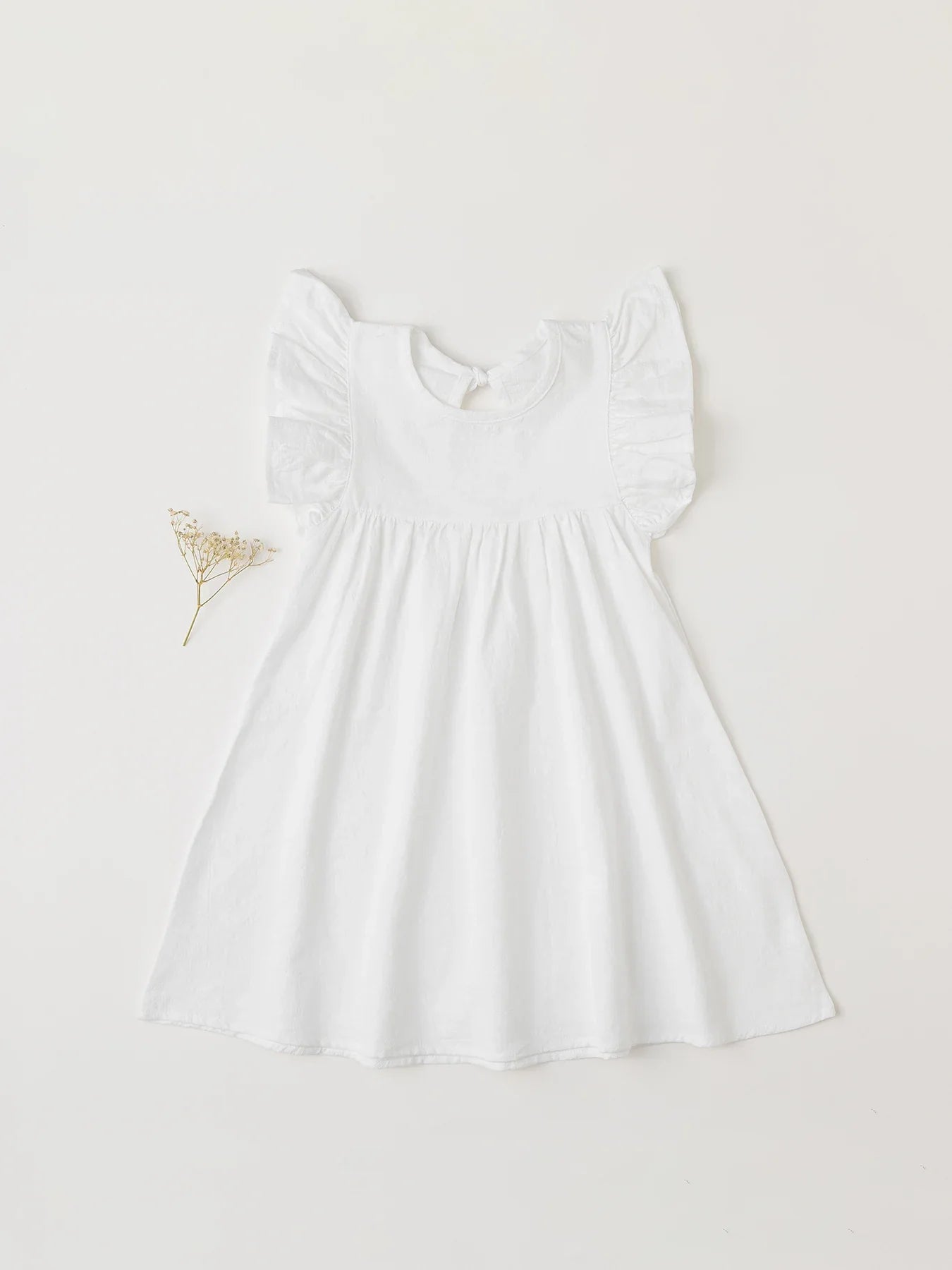 Chambray blue cotton overall dress with tie-back for a casual summer toddler style