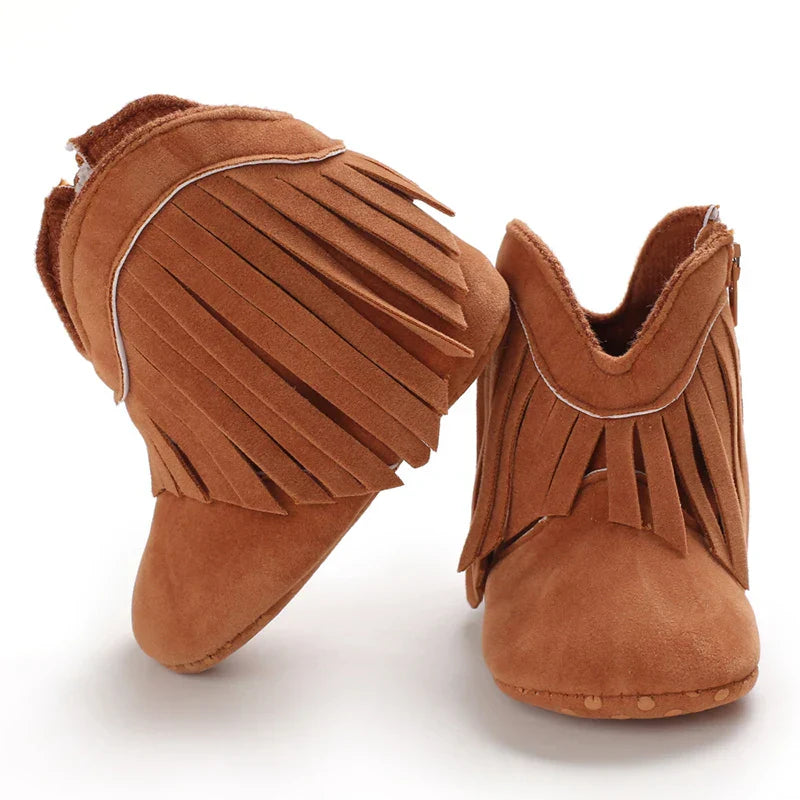 Little girl wearing white fringe cowboy boots, a fashionable choice for toddler western wear.