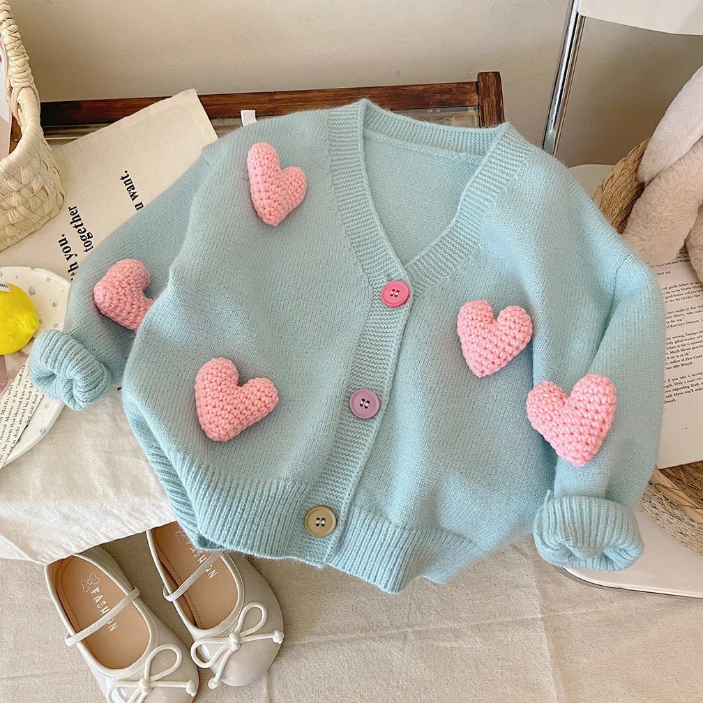 Close-up of heart design knit sweater for girls, soft cotton blend, perfect fall clothing for toddlers