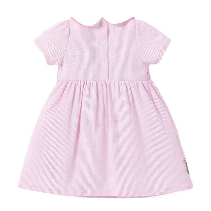 Close-up of the delicate rabbit print on a girls' pink cotton blend summer dress, perfect for kids.