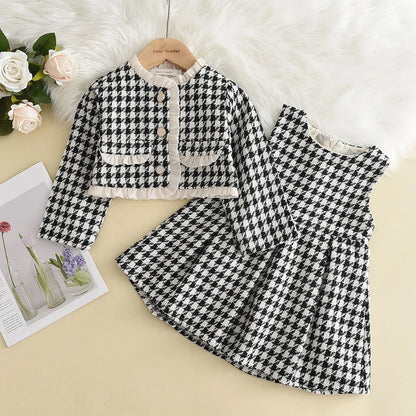 Happy toddler girl smiling while wearing a comfortable pink checkered two-piece outfit, long-sleeve