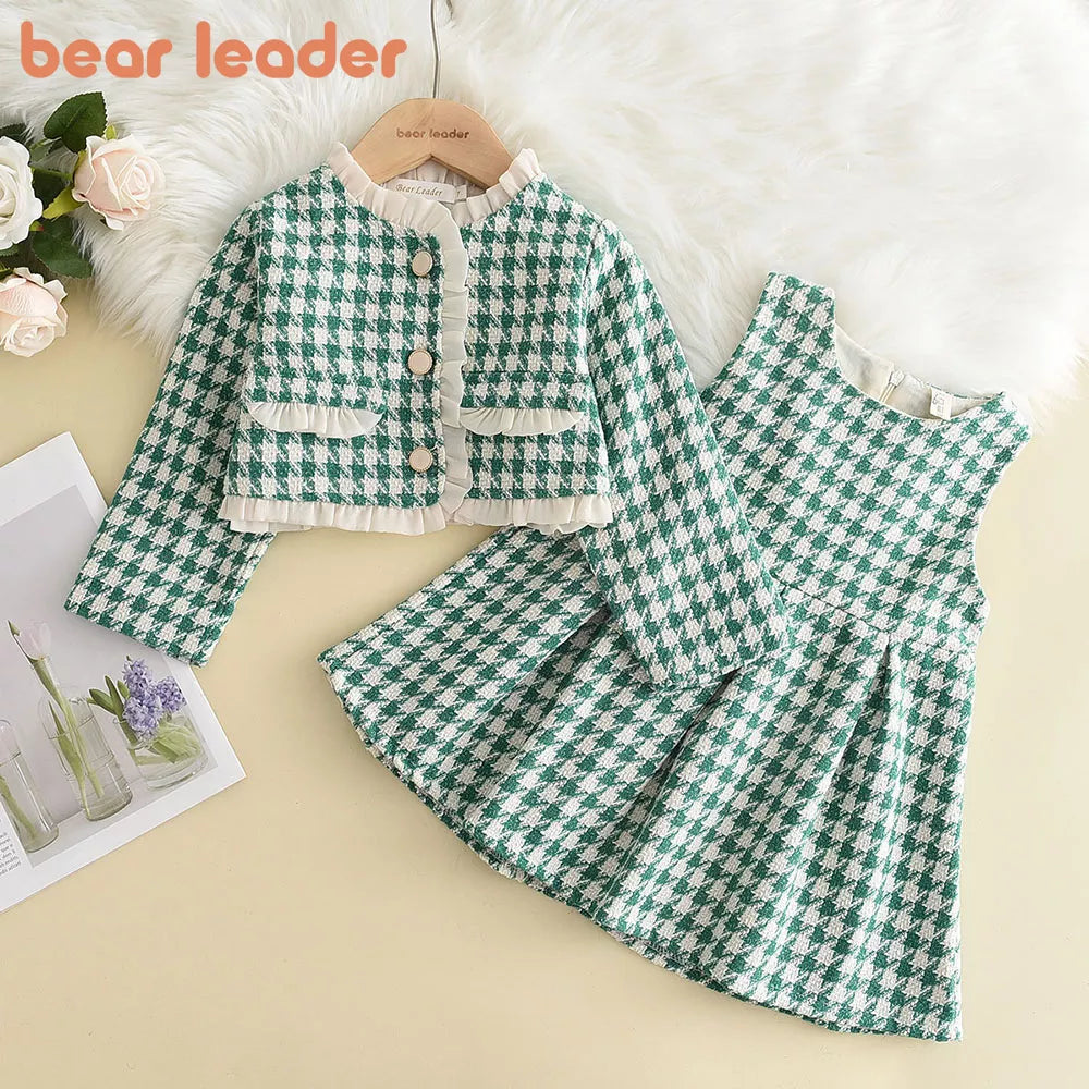 Close-up of soft pink and white checkered pattern on a girls' cozy long-sleeve top for toddlers
