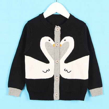 Detail of the buttons on a baby girl's plaid knitted cardigan sweater, quality finish