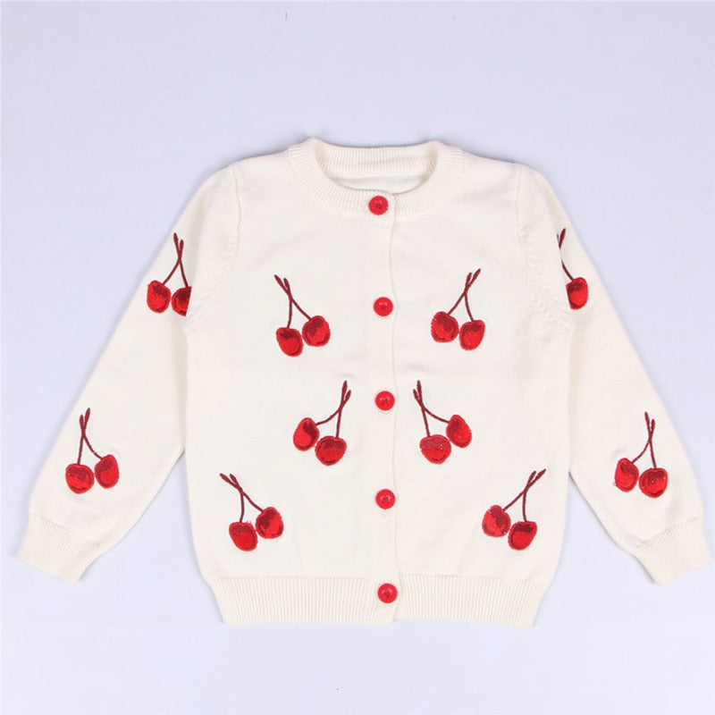 Side view of a toddler girl's plaid knitted cardigan, cozy outerwear design
