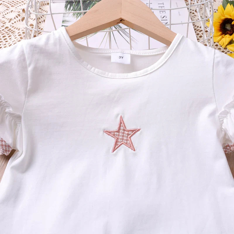 Two-piece toddler girl's star print summer set featuring a short-sleeve top and matching shorts.
