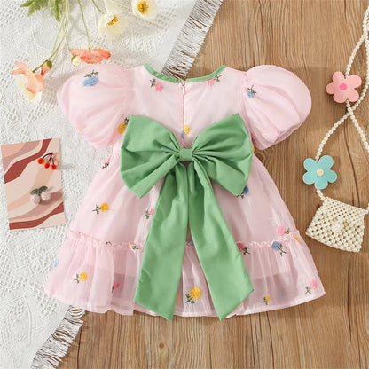 Cute toddler girl's floral dress with a unique back bow, perfect for spring outings.