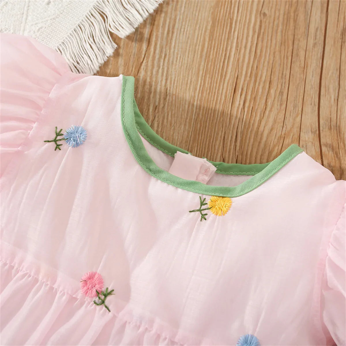 Fashionable girls' summer dress, detailed with a beautiful floral print and back bow.