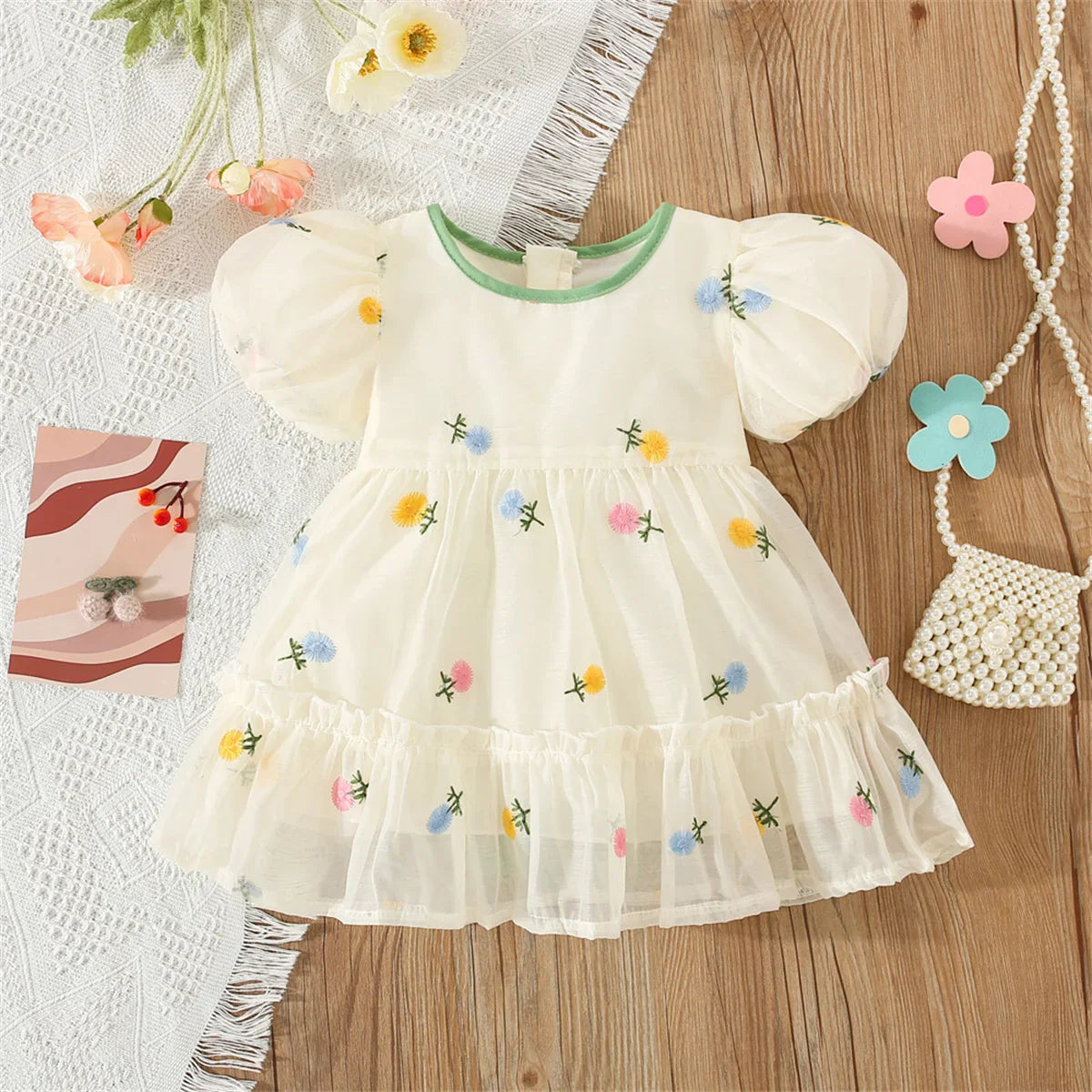 Kids fashion: Girls' summer dress with a vibrant flower pattern and adorable bow back.