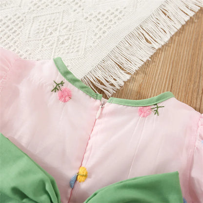 Spring apparel: Baby girl's casual floral party dress with charming back bow detail.