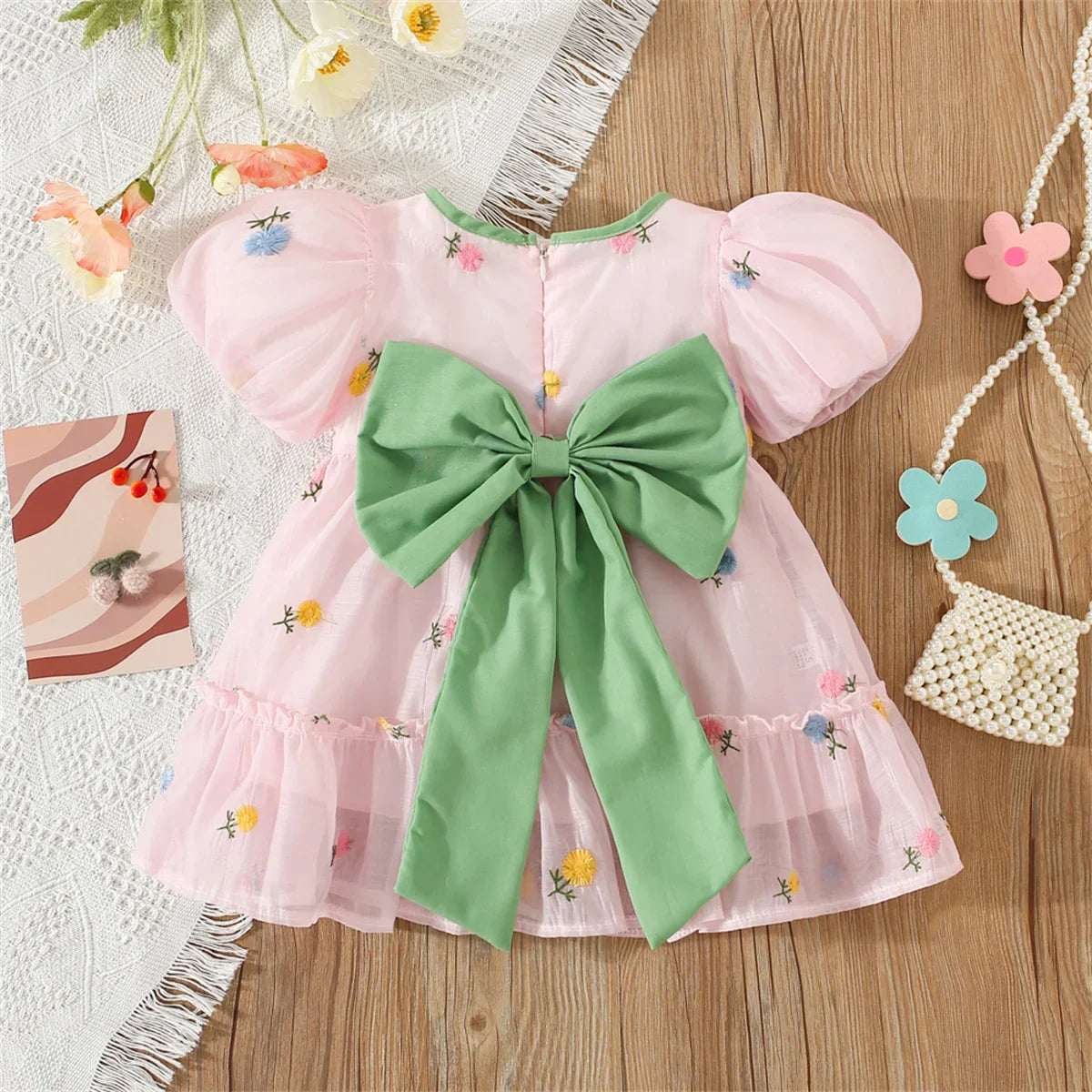 Full length view of a girls' back bow flower dress, suitable for warm weather.