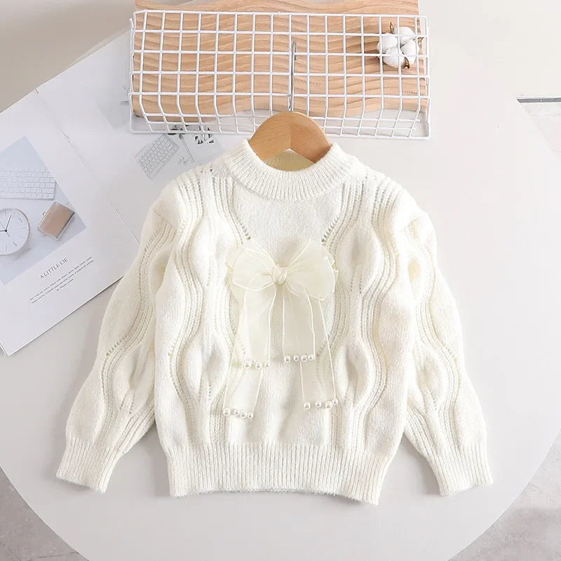 Toddler girl's warm pink knitted long-sleeve sweater with bow detail, cotton blend