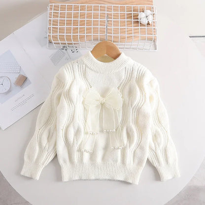 Toddler girl's warm pink knitted long-sleeve sweater with bow detail, cotton blend