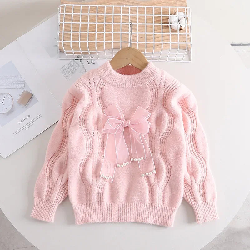 Soft knitted pullover top for girls, featuring a cute bow and cozy winter fashion