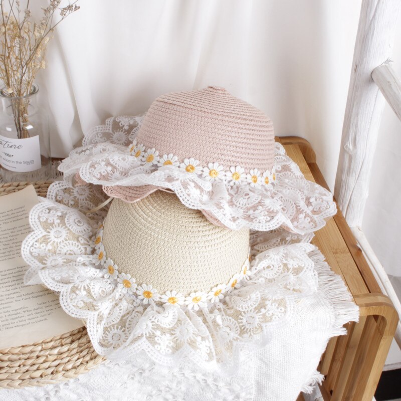 Back view of a kids' sunflower straw hat, highlighting the adjustable sizing band