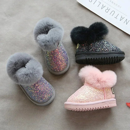 Toddler girl wearing pink glitter winter boots, perfect for warmth and style
