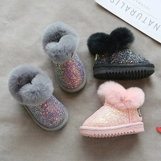 Toddler girl wearing pink glitter winter boots, perfect for warmth and style