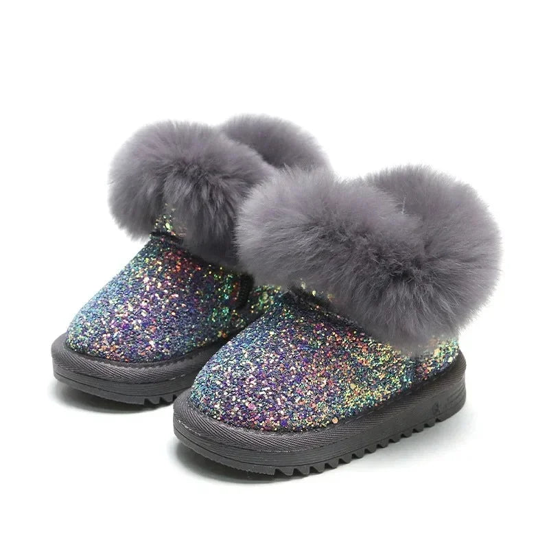 Close-up of children's warm glitter winter boots, showing textured sole for grip