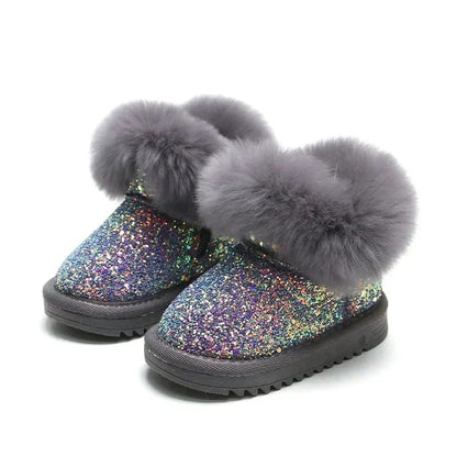 Close-up of children's warm glitter winter boots, showing textured sole for grip