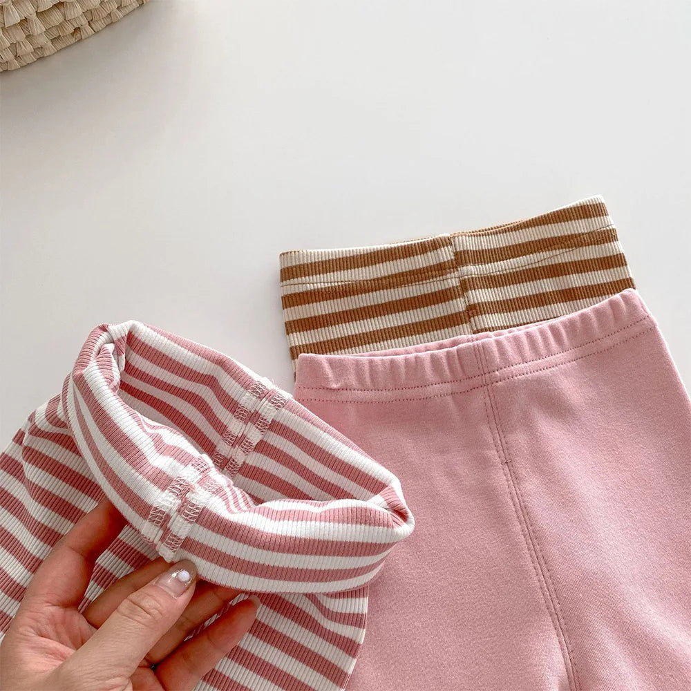 Active child playing outdoors in durable, comfortable black cotton leggings for daily wear.