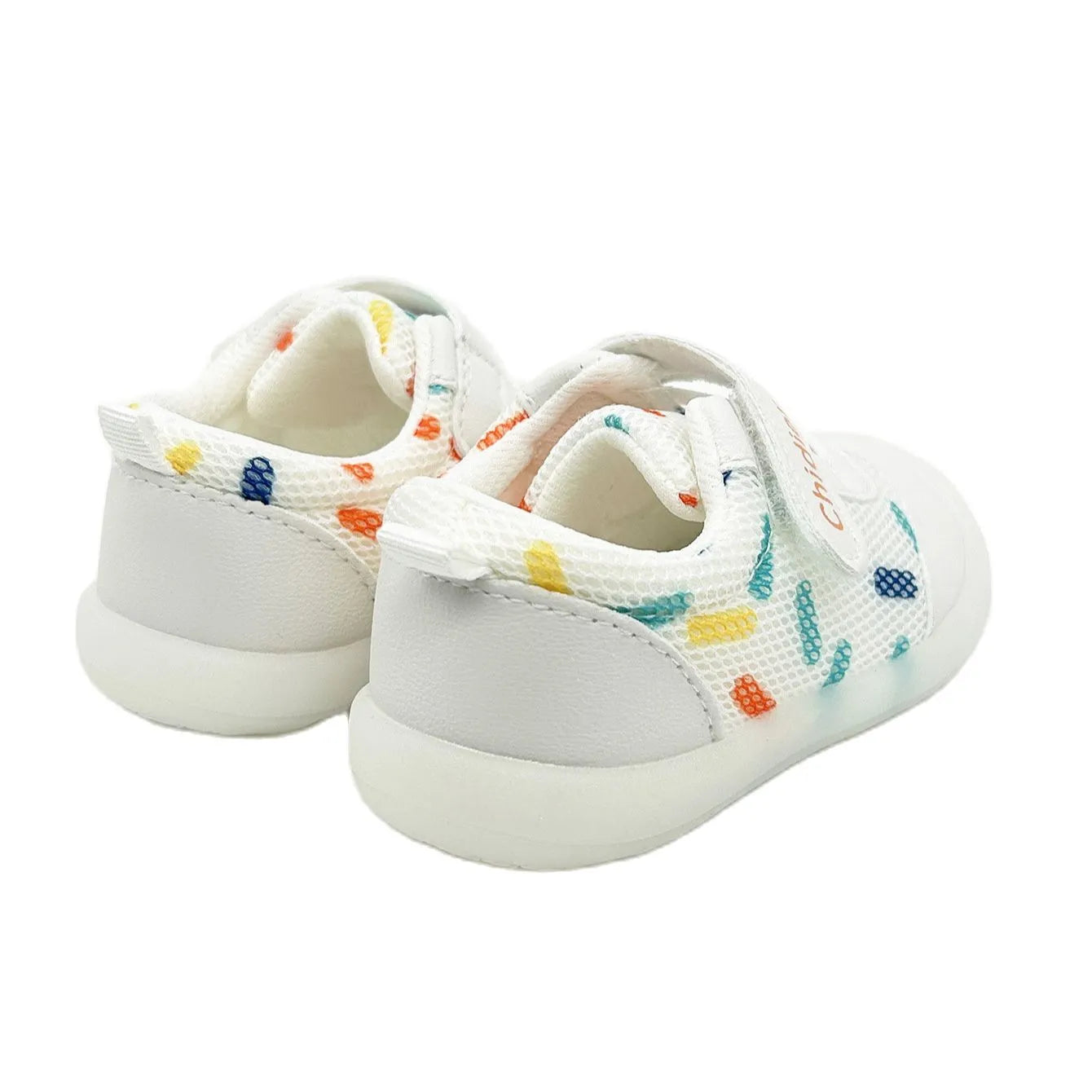 Close-up of pink and white polka dot toddler shoes, showcasing breathable fabric and secure hook and loop fastener.