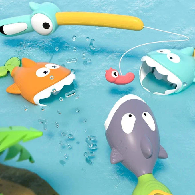 Close-up of child's hand holding magnetic fishing rod, catching a bright orange fish bath toy