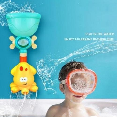 Toddler happily playing with a yellow Fun Faucet Shower Spray Bath Toy, water flowing into tub.