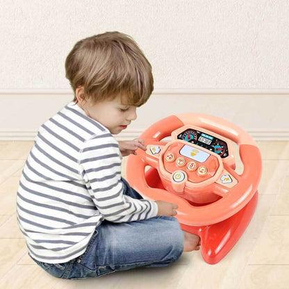 Toddler happily playing with interactive driving wheel toy, perfect for car activity simulation.