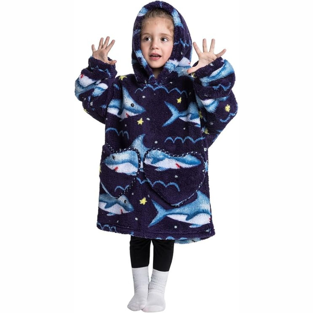 Toddler wrapped in hooded blanket with sleeves & pockets, relaxing at home, soft Sherpa fleece