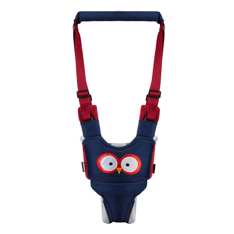 Parent holding the handle of a toddler walking harness, assisting their child learning to walk.