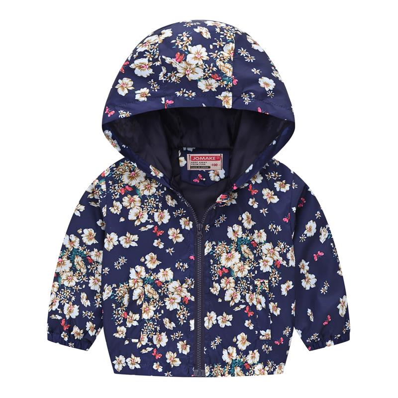 Toddler girl smiling in a vibrant floral hooded windbreaker jacket, cozy and playful fall clothing.