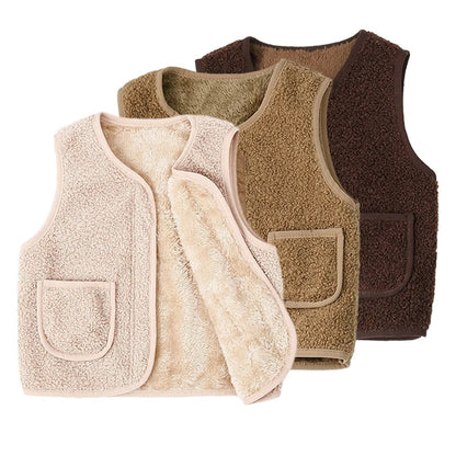 Toddler in a cozy cream lambswool cardigan vest, perfect for winter layering and warmth on a cold day.